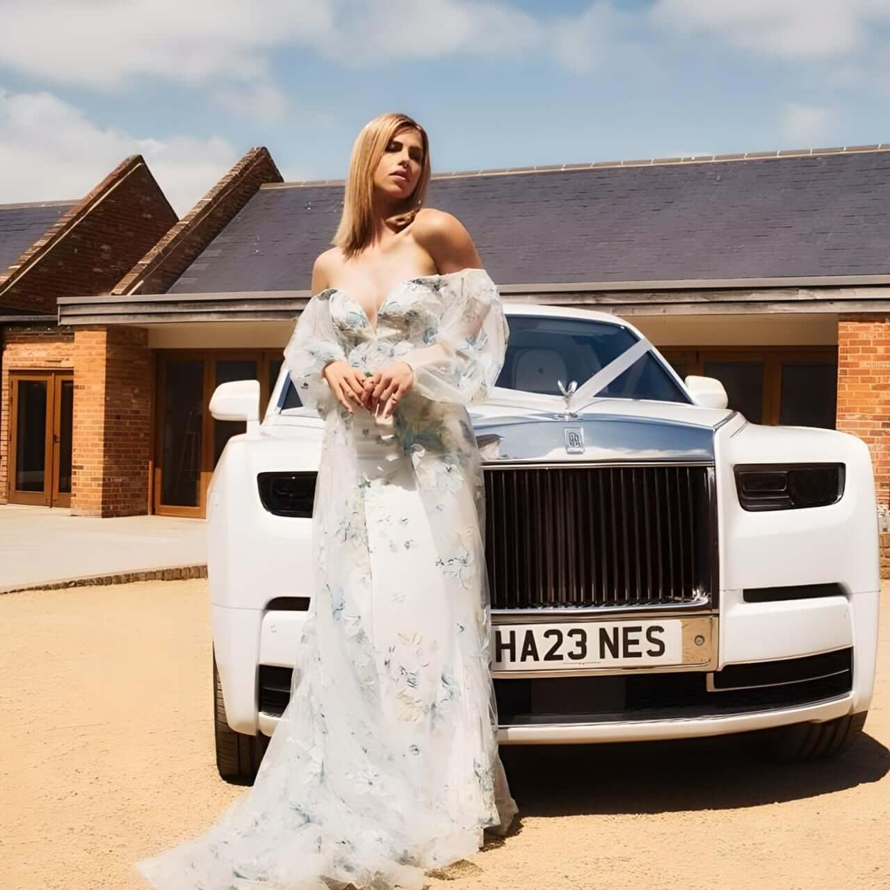 SJ Chauffeurs: Elegant white Rolls Royce with person in dress, perfect for luxurious wedding transport or special events