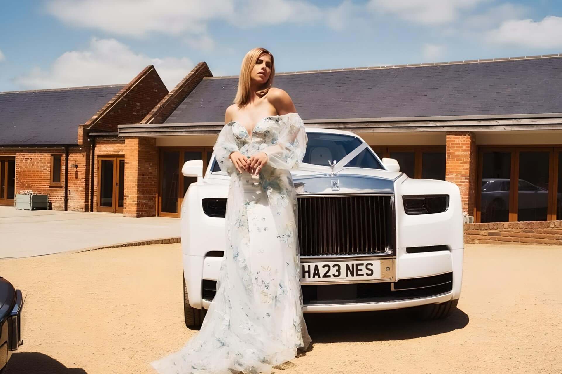 SJ Chauffeurs: Elegant white Rolls Royce with person in dress, perfect for luxurious wedding transport or special events