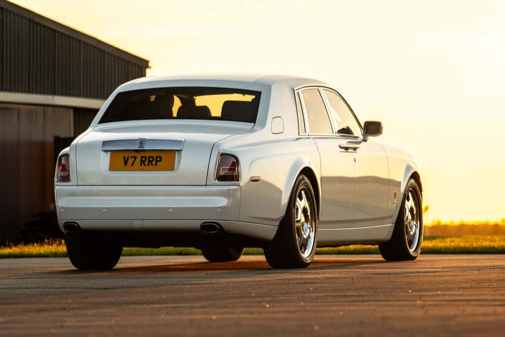 Luxury white Rolls-Royce Phantom at sunset, exuding elegance and prestige. Experience VIP chauffeur hire with SJ Chauffeurs, offering executive travel, wedding transport, and luxury event services across the UK. Travel in style—book your Rolls-Royce Phantom chauffeur today!